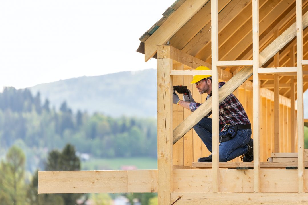 roofer builder working on roof structure at construction site.jpg